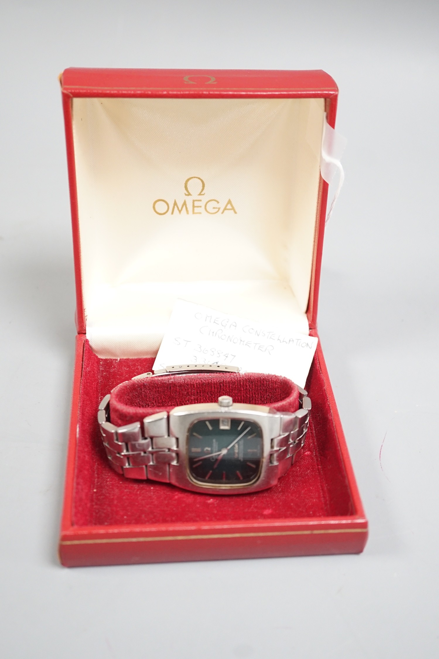 A gentleman's early 1970's stainless steel Omega Constellation chronometer black dial wrist watch, with bate numerals and date aperture, on stainless steel Omega bracelet, case diameter 33mm, with Omega box.